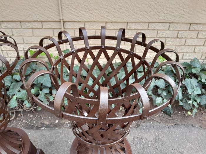 A 20th Century Pair of Decorative Wrought Iron Urns on Plinths