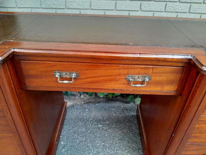 An Antique Victorian Mahogany Desk With Tooled Leather Top