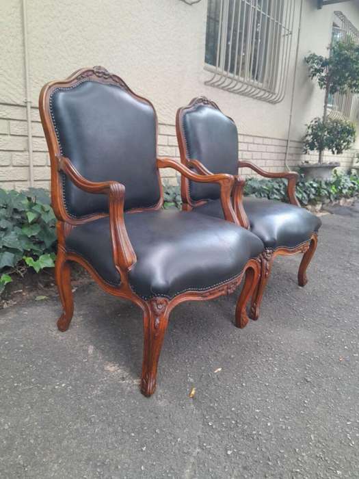 A 20th Century Pair or Carved Mahogany Armchairs Upholstered In Leather