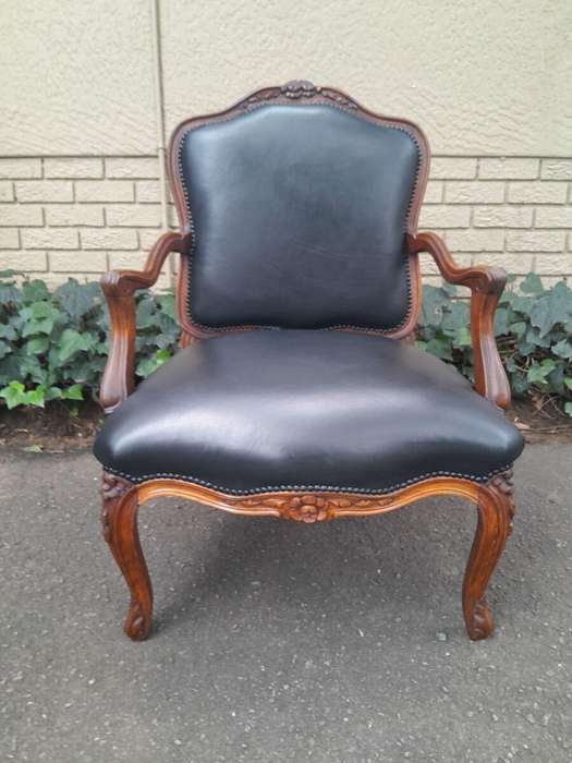 A 20th Century Pair or Carved Mahogany Armchairs Upholstered In Leather