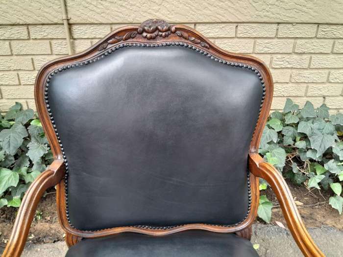 A 20th Century Pair or Carved Mahogany Armchairs Upholstered In Leather