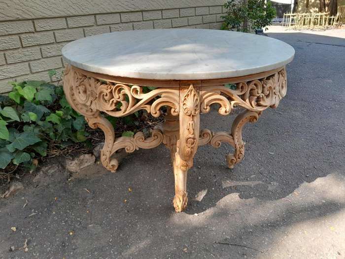 A20th Century Rococo Style Heavily Carved Teak Table with White Marble Top in a Contemporary Blea...