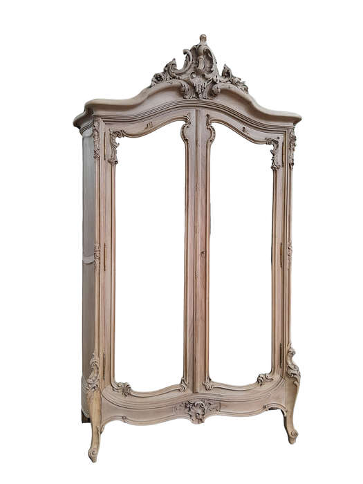 An Antique French Heavily Carved Oakd Two Door Armoire with Bevelled Mirrors and Four Shelves