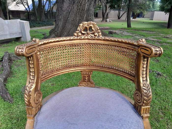A Pair of French Louis XVI Style Carved and Rattan Chairs