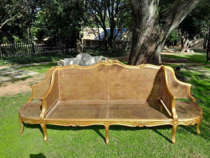 A 20th Century French Style Carved and Gilded Conversation Settee in Rattan