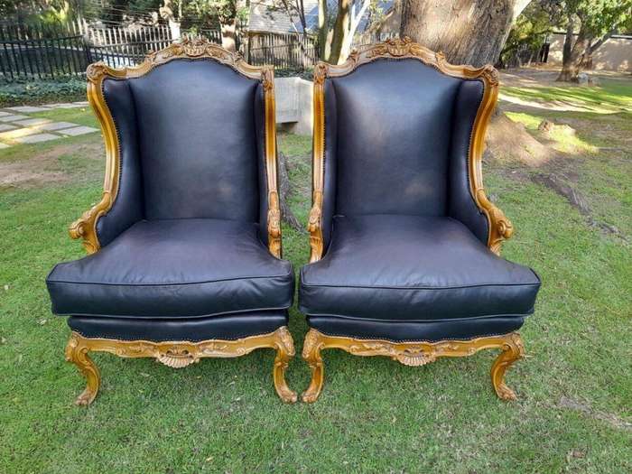 A 20th Century Pair Of French Louis XVI Style Carved Wingback Armchairs