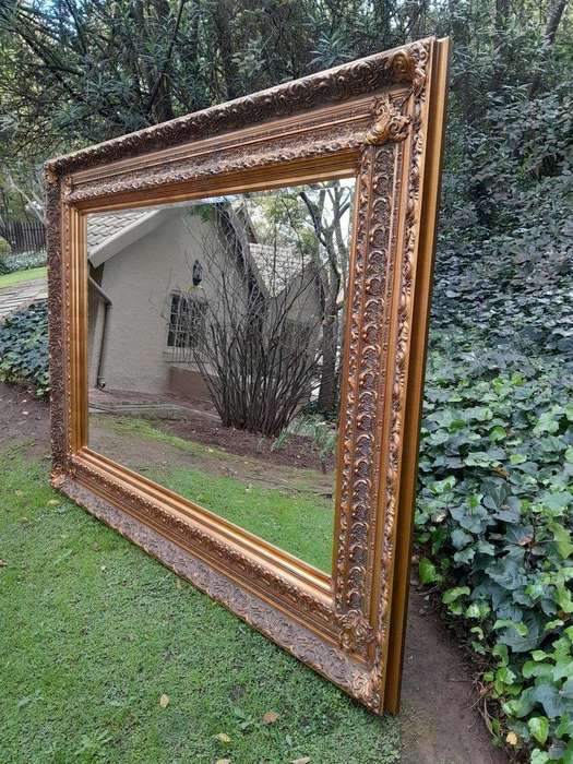 A 20th Century Heavily Carved And Bevelled Framed Mirror Of Large Proportions