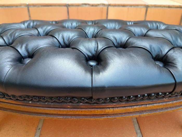 A 20th Century French Style Carved Beechwood Foot Stool Upholstered In Deep Buttoned Leather