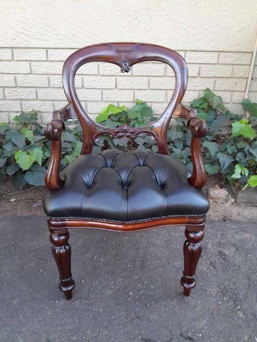 A 20th Century Set Of Twelve Teak Wood Bustle Back Chairs Comprising A Pair Of Carvers / Armchair...