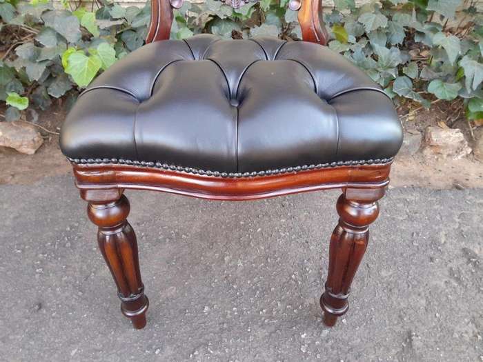 A 20th Century Set Of Twelve Teak Wood Bustle Back Chairs Comprising A Pair Of Carvers / Armchair...