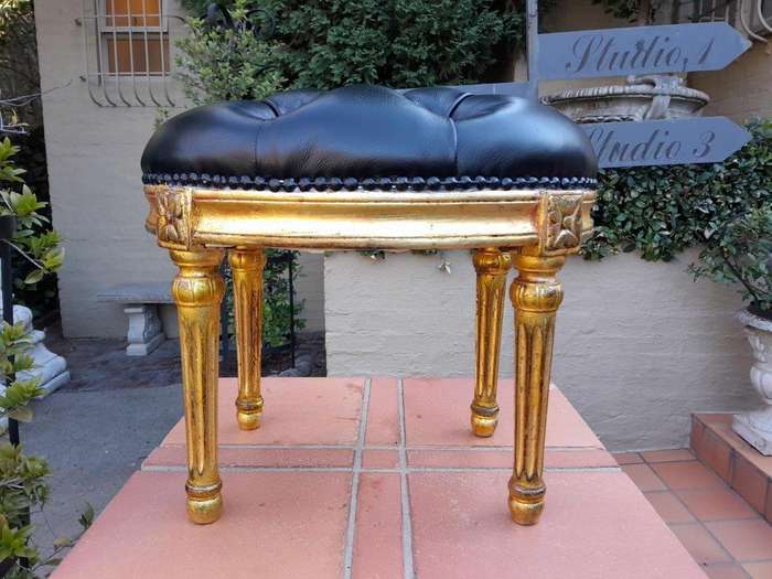 A 20th Century French-Style Beechwood Carved Footstool In A Hand Gilded Finish And Upholstered In...