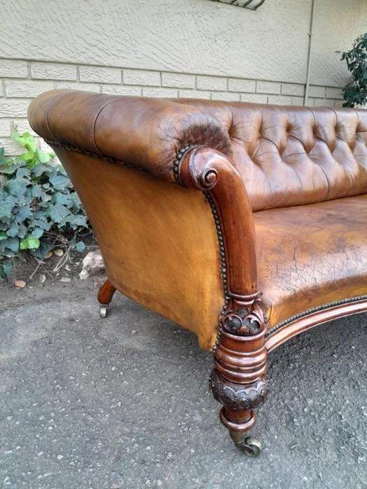 An Antique 19th Century Chesterfield Settee With Original Leather And Castors
