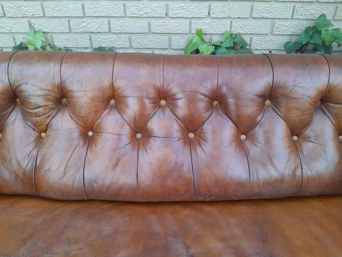 An Antique 19th Century Chesterfield Settee With Original Leather And Castors