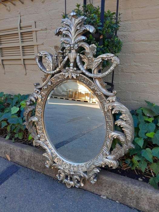 A French Style Ornately Carved And Bevelled Mirror In A Contemporary Silver Hand-Gilded Finish