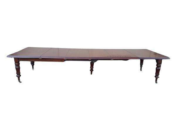 An Antique  Circa 1880s Victorian Mahogany Extending Dining Table On Castors With Four Leaves A...