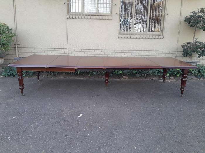 An Antique  Circa 1880s Victorian Mahogany Extending Dining Table On Castors With Four Leaves A...
