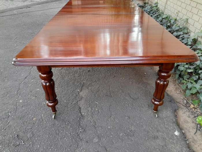 An Antique  Circa 1880s Victorian Mahogany Extending Dining Table On Castors With Four Leaves A...