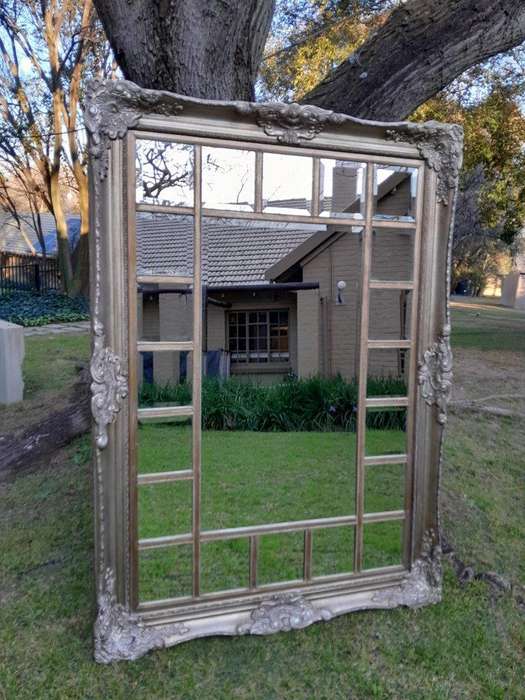 A 20th Century French Style Ornately Carved, Gilt Painted And Bevelled Mirror