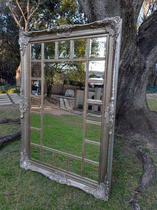 A 20th Century French Style Ornately Carved, Gilt Painted And Bevelled Mirror