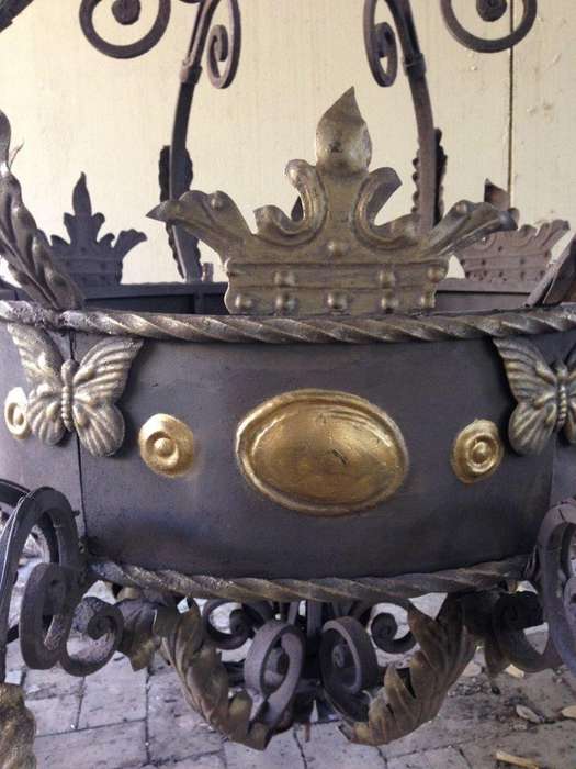 A Large Wrought Iron and Hand-Painted Imported Chandelier with Crown Detail