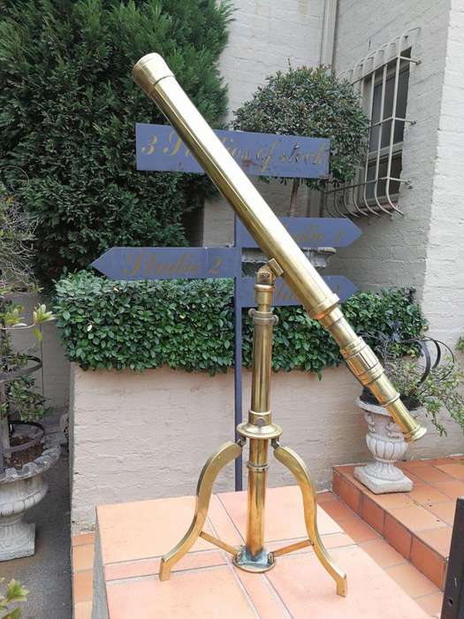 An Antique Brass Floor Standing Telescope On Tripod With Lens Cover