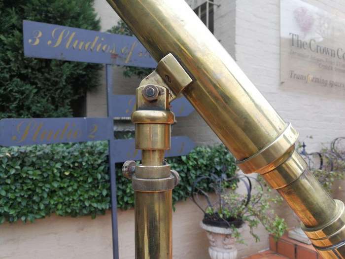 An Antique Brass Floor Standing Telescope On Tripod With Lens Cover