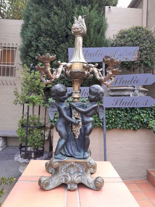 An Antique Brass And Bronze Five Arm Cherub Candelabra
