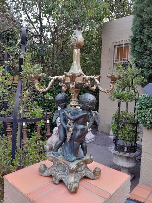 An Antique Brass And Bronze Five Arm Cherub Candelabra