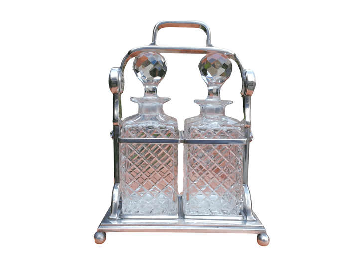 A Silver- Plate Tantalus With Two Cut-Glass Decanters