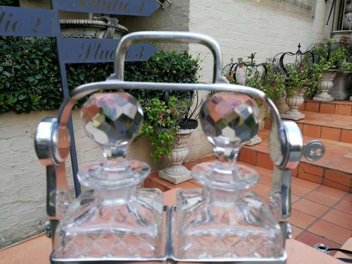 A Silver- Plate Tantalus With Two Cut-Glass Decanters