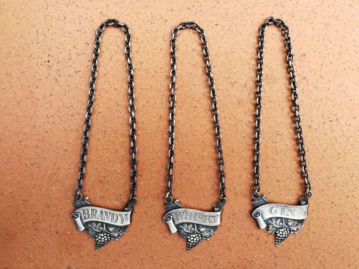 A Set of Three Birmingham Silver Decanter Labels Silver weight: 34 grams