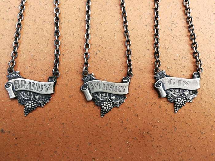 A Set of Three Birmingham Silver Decanter Labels Silver weight: 34 grams