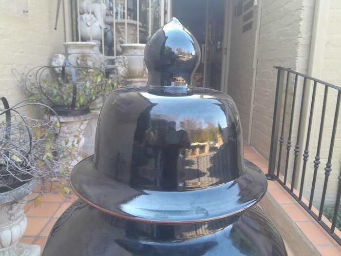 A Large Size Black Ceramic Ginger Car With Cover On A Chinese Wooden Stand