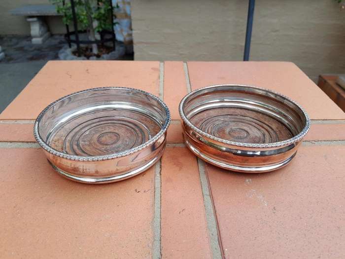 A 20th Century Pair of Silver- plate Wine Coasters with Wooden Bases