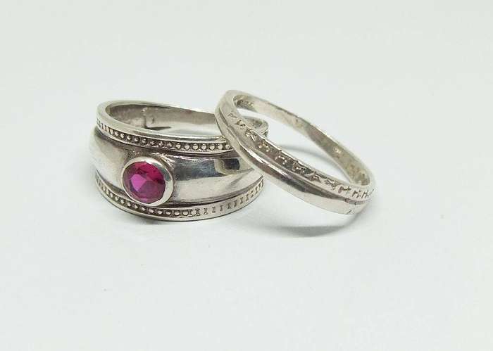 A beautiful two piece sterling silver ring with ruby coloured faceted inset