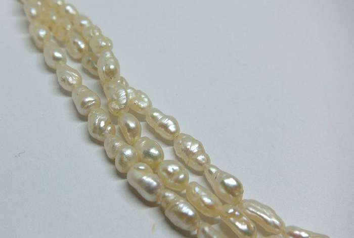 A vintage triple strand genuine Freshwater seed pearl necklace with 835 German silver clasp