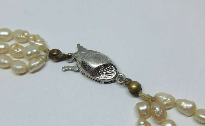 A vintage triple strand genuine Freshwater seed pearl necklace with 835 German silver clasp