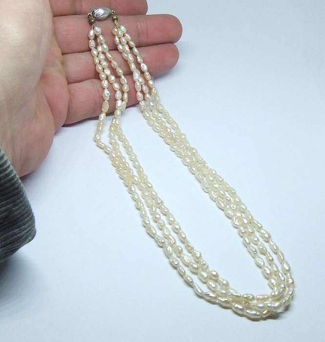 A vintage triple strand genuine Freshwater seed pearl necklace with 835 German silver clasp