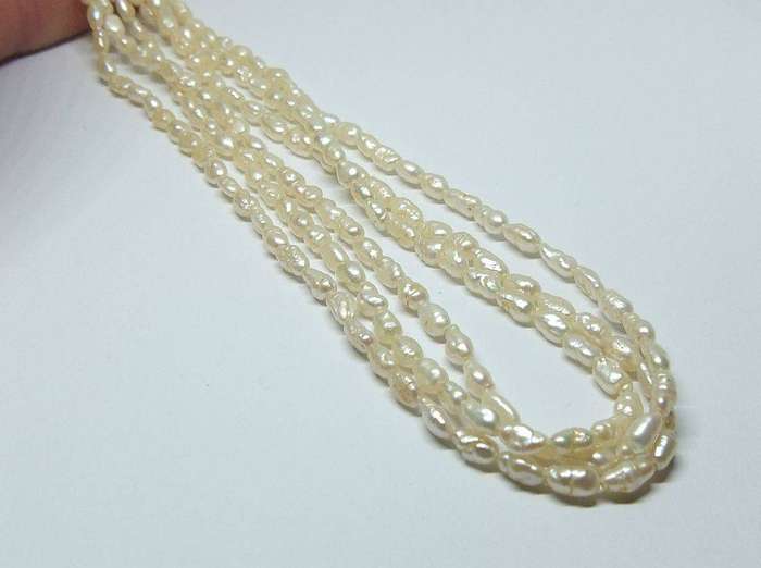 A vintage triple strand genuine Freshwater seed pearl necklace with 835 German silver clasp