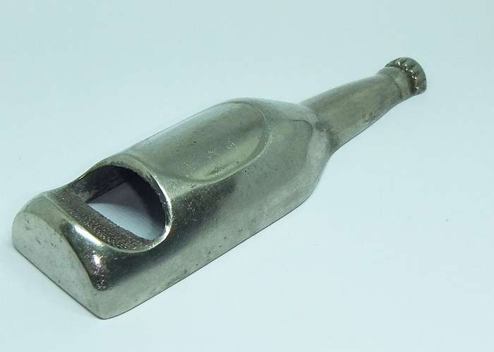A VINTAGE BOTTLE FORM BOTTLE OPENER