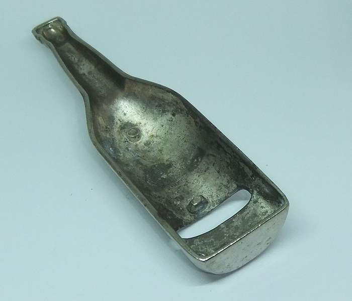 A VINTAGE BOTTLE FORM BOTTLE OPENER