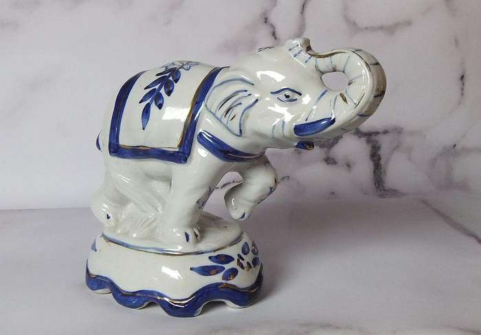 AN EYE CATCHING VINTAGE HANDPAINTED AND GLAZED CLAY ELEPHANT ON PLINTH IN EXCELLENT CONDITION