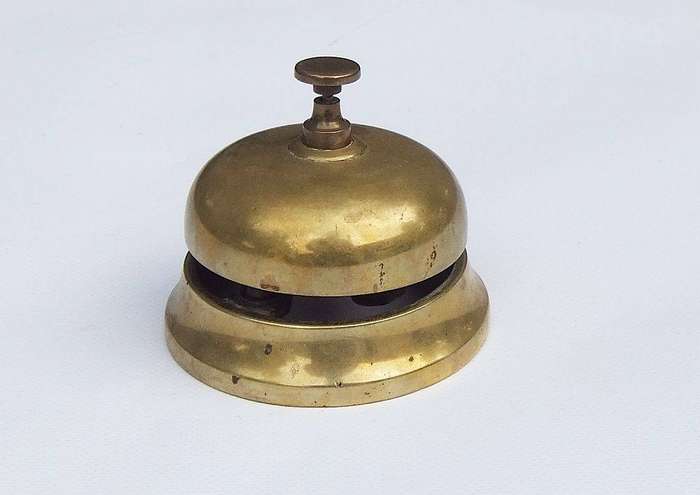A vintage solid brass reception bell in working condition