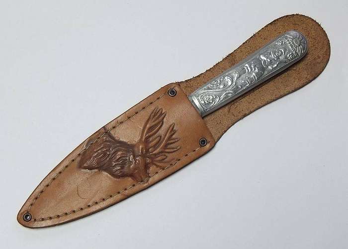 A rare vintage detailed Argentinian Gaucho knife with genuine leather pouch depicting a stag