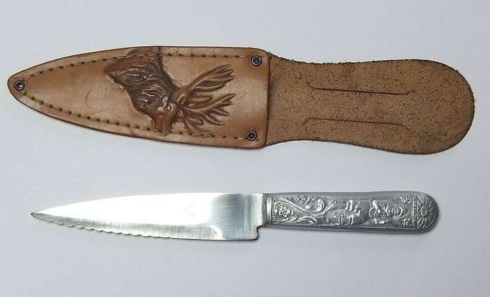 A rare vintage detailed Argentinian Gaucho knife with genuine leather pouch depicting a stag