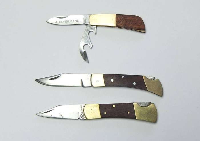 A lot of three vintage brass and wood folding pocket knives