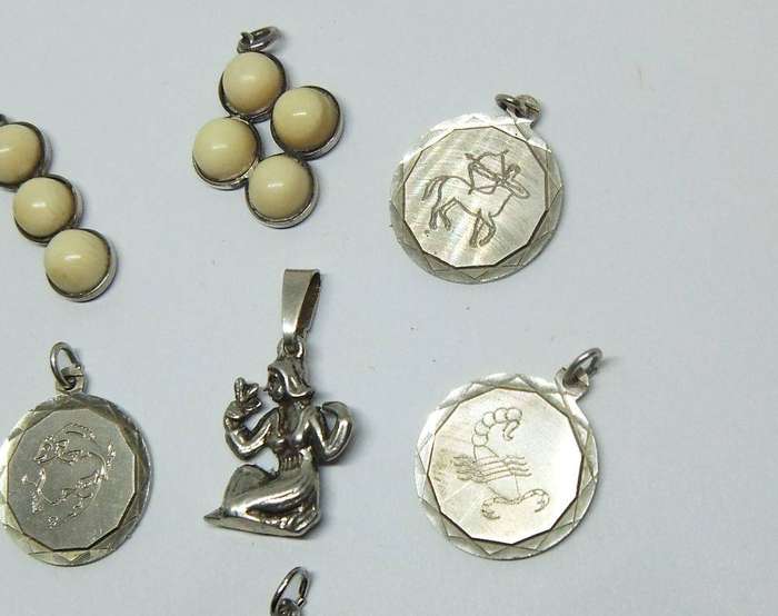 A lot of 9 vintage solid silver pendants and one sterling silver island charm