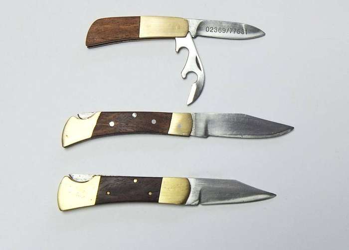 A lot of three vintage brass and wood folding pocket knives