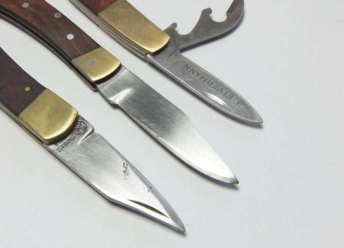 A lot of three vintage brass and wood folding pocket knives