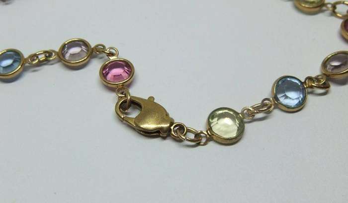 A stunning vintage gold plated necklace with faceted coloured glass insets